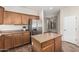 Kitchen with island, stainless steel refrigerator, oak cabinets and view to breakfast nook at 4507 E Lantern Pl, Gilbert, AZ 85297