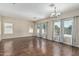 Spacious living room with wood floors, neutral paint, and large windows offering ample natural light at 4507 E Lantern Pl, Gilbert, AZ 85297