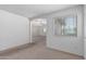 Bright, open living room features neutral color palette, plush carpeting, and archway to adjacent living spaces at 4507 E Lantern Pl, Gilbert, AZ 85297