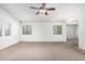Living room featuring carpet flooring, neutral paint and multiple windows at 4507 E Lantern Pl, Gilbert, AZ 85297
