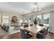 Bright living room with dining area, wood floors, and view of backyard pool at 4507 E Lantern Pl, Gilbert, AZ 85297