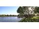 Scenic pond view with a wooden pier surrounded by mature trees and lush greenery in a peaceful park setting at 4507 E Lantern Pl, Gilbert, AZ 85297