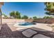 Backyard pool and patio with desert landscaping and privacy wall at 4507 E Lantern Pl, Gilbert, AZ 85297