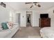 Bedroom featuring carpet, ceiling fan, and neutral colored walls with view of sofa at 5 N 87Th Ln, Tolleson, AZ 85353
