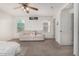 Bedroom featuring carpet, ceiling fan, and neutral colored walls with sofa at 5 N 87Th Ln, Tolleson, AZ 85353
