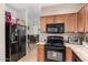 Kitchen featuring black appliances and light colored cabinets with a view of dining room at 5 N 87Th Ln, Tolleson, AZ 85353