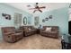 Inviting living room featuring comfortable seating, neutral tile flooring, and ample natural light at 5 N 87Th Ln, Tolleson, AZ 85353