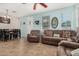 Comfortable living room with neutral tile, plush sofas, and open access to the dining area at 5 N 87Th Ln, Tolleson, AZ 85353
