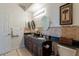 Bathroom features a granite countertop, double sink, oval mirrors, neutral tile, and towel rack at 5335 E Shea Blvd # 2081, Scottsdale, AZ 85254