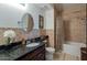 Granite countertop, oval mirror, neutral tile, and combination tub and shower shown in bathroom at 5335 E Shea Blvd # 2081, Scottsdale, AZ 85254