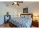 Bright bedroom features ceiling fan, comfortable queen bed, stylish furnishings, and warm lighting at 5335 E Shea Blvd # 2081, Scottsdale, AZ 85254