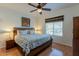 Warm bedroom features modern ceiling fan, comfortable queen bed, stylish window treatments, and a bright window at 5335 E Shea Blvd # 2081, Scottsdale, AZ 85254