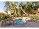 Community hot tub surrounded by lounge chairs and lush landscaping for relaxation at 5335 E Shea Blvd # 2081, Scottsdale, AZ 85254