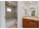 Bathroom featuring a large shower and a vanity area with light wood cabinets at 581 S Roosevelt St, Tempe, AZ 85281