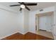 Bright bedroom featuring a ceiling fan, hardwood floors, and ensuite bathroom access at 581 S Roosevelt St, Tempe, AZ 85281