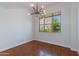 Bright dining room with hardwood floors, modern light fixture, and a large window showcasing the outside view at 581 S Roosevelt St, Tempe, AZ 85281