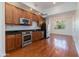 Modern kitchen featuring stainless steel appliances, dark countertops, and wood cabinets at 581 S Roosevelt St, Tempe, AZ 85281