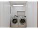 Laundry room with LG washer and dryer and custom overhead storage at 581 S Roosevelt St, Tempe, AZ 85281