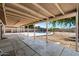 Covered back patio offering a serene view of the pool and garden, perfect for outdoor entertaining at 5841 W Kesler St, Chandler, AZ 85226