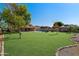 Expansive backyard featuring a well-maintained lawn and a sparkling swimming pool, perfect for outdoor enjoyment at 5841 W Kesler St, Chandler, AZ 85226