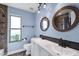 Bathroom featuring dual vanity sinks with framed mirrors, and a shower and tub combination with mosaic tiles at 5841 W Kesler St, Chandler, AZ 85226