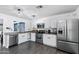 White kitchen featuring stainless steel appliances, ample countertop space, and modern fixtures at 5841 W Kesler St, Chandler, AZ 85226
