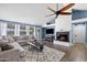Bright living room with a cozy fireplace, vaulted ceilings, large sectional sofa, and views to the backyard at 5841 W Kesler St, Chandler, AZ 85226
