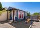 Quaint outbuilding with a porch and a play structure in the backyard at 5841 W Kesler St, Chandler, AZ 85226