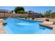 Sparkling swimming pool with blue tile, bordered by concrete and a small backyard at 5841 W Kesler St, Chandler, AZ 85226