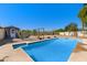 Inviting swimming pool with an adjacent pool house, enhanced by a lush, landscaped backyard for ultimate relaxation at 5841 W Kesler St, Chandler, AZ 85226
