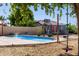 Refreshing swimming pool with a fun rope swing and charming pool house, ideal for summer relaxation at 5841 W Kesler St, Chandler, AZ 85226
