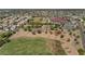 An aerial view highlighting a neighborhood park with tennis courts, playground, grassy fields, and a nearby school at 8599 W Athens St, Peoria, AZ 85382