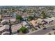An aerial view showcasing a residential area with diverse home styles, neat yards, and a mix of desert and green landscaping at 8599 W Athens St, Peoria, AZ 85382