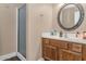 Bathroom with a single vanity, wood cabinet and a shower with glass doors at 8599 W Athens St, Peoria, AZ 85382