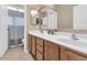 Bright bathroom features a double sink vanity, tile floors and shower-tub combo at 8599 W Athens St, Peoria, AZ 85382