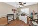Bedroom with hardwood floors, ceiling fan and crafting area at 8599 W Athens St, Peoria, AZ 85382