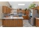 Spacious kitchen with stainless steel appliances, oak cabinets, and a bright skylight at 8599 W Athens St, Peoria, AZ 85382