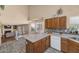 Open kitchen area with an island, tiled floors, and a view into the living room at 8599 W Athens St, Peoria, AZ 85382
