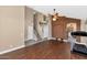 Open-concept living space with wood floors, a staircase, and access to the kitchen at 8599 W Athens St, Peoria, AZ 85382