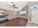 Comfortable living area featuring wood floors, a ceiling fan, and lots of natural light at 8599 W Athens St, Peoria, AZ 85382