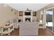 Cozy living room features a fireplace, stylish decor, and a sliding door to the backyard at 8599 W Athens St, Peoria, AZ 85382