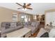 Bright living room boasts hardwood floors, neutral paint, and a view into the kitchen at 8599 W Athens St, Peoria, AZ 85382