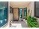 Front entryway featuring a neutral colored door, potted plants, and decorative cacti at 9389 N 87Th Way, Scottsdale, AZ 85258