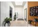 Bright hallway with tile flooring and natural light, featuring artwork and plants at 9389 N 87Th Way, Scottsdale, AZ 85258
