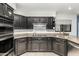 Kitchen featuring black cabinets, granite countertops, and stainless steel appliances at 9389 N 87Th Way, Scottsdale, AZ 85258