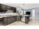 Kitchen featuring black cabinets and stainless steel appliances and island with granite countertops at 9389 N 87Th Way, Scottsdale, AZ 85258