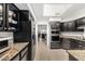 Kitchen featuring black cabinets and granite countertops with stainless steel appliances at 9389 N 87Th Way, Scottsdale, AZ 85258