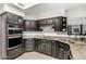 Well-lit kitchen featuring black cabinets, granite countertops, and stainless steel appliances at 9389 N 87Th Way, Scottsdale, AZ 85258