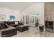 Bright living room featuring a gray sectional couch and sliding doors to the backyard at 9389 N 87Th Way, Scottsdale, AZ 85258