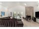 Bright living room featuring a stone fireplace and sliding doors to the backyard at 9389 N 87Th Way, Scottsdale, AZ 85258
